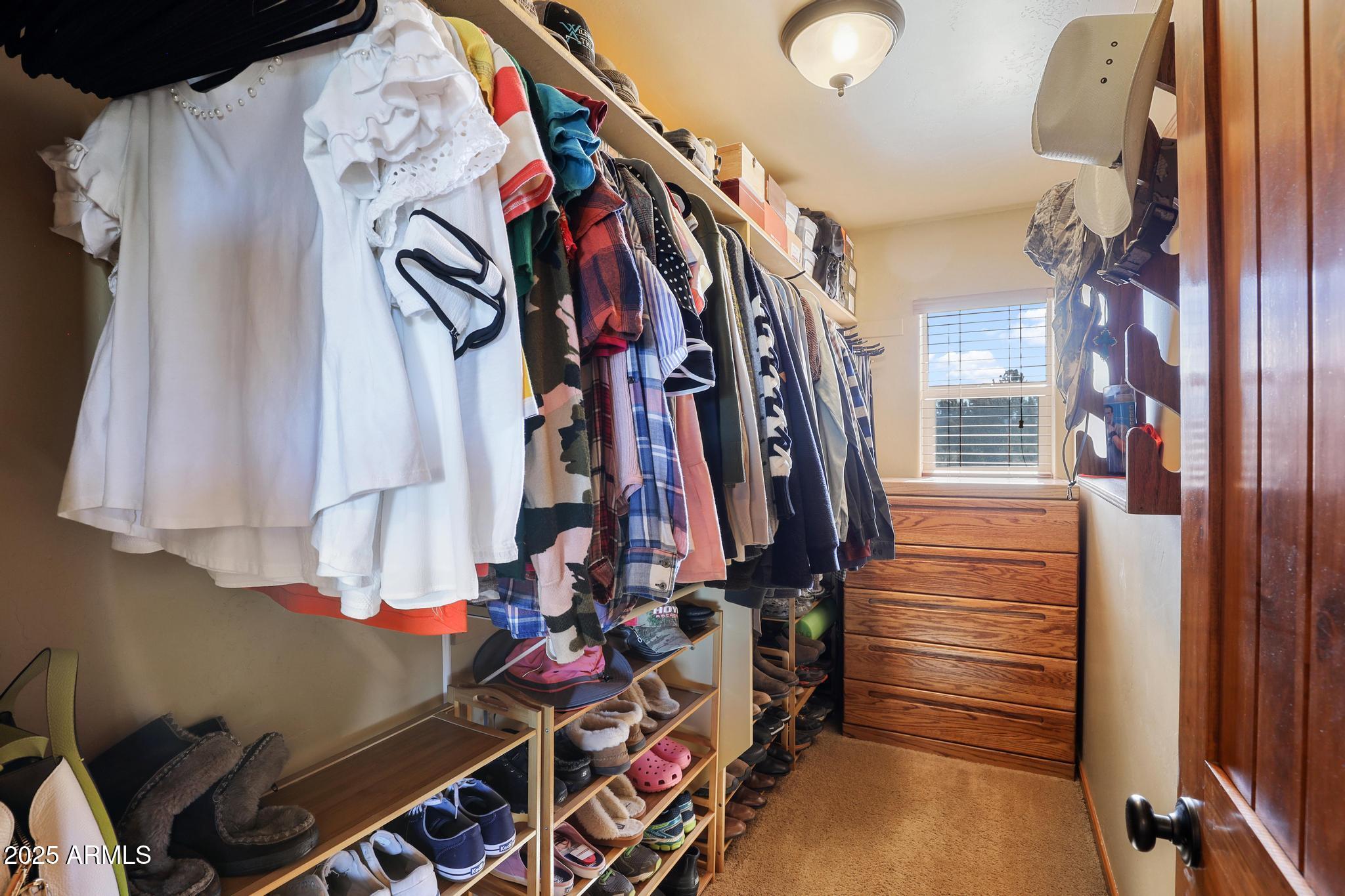4018 Sunset Rdg Loop Happy Jack, AZ 86024 - Photo 18 of 46 a view of walk in closet with clothes