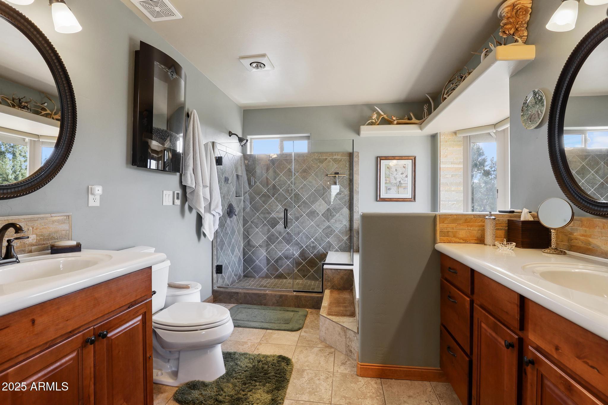 4018 Sunset Rdg Loop Happy Jack, AZ 86024 - Photo 19 of 46 a bathroom with a sink a toilet and shower