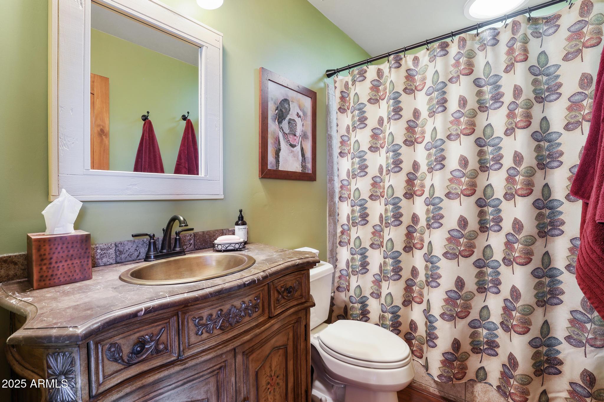 4018 Sunset Rdg Loop Happy Jack, AZ 86024 - Photo 24 of 46 a bathroom with a granite countertop toilet sink and mirror