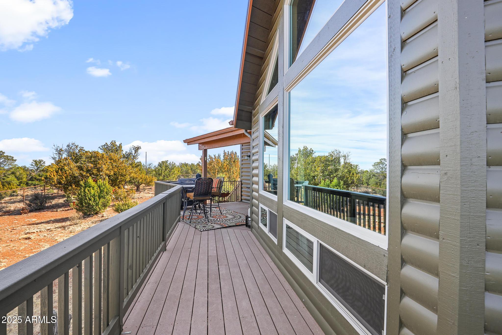 4018 Sunset Rdg Loop Happy Jack, AZ 86024 - Photo 29 of 46 a view of a balcony with chairs and wooden floor
