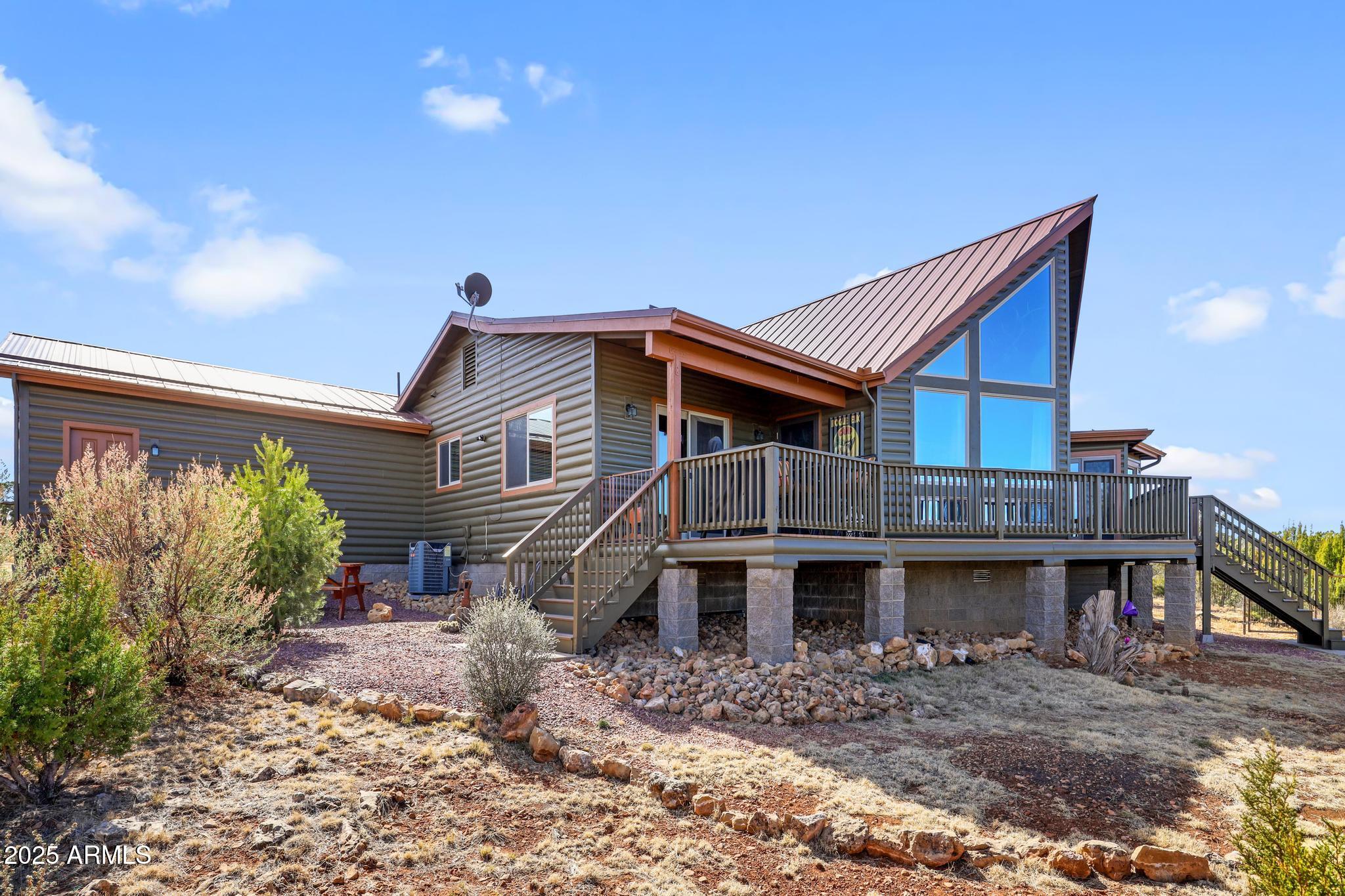 4018 Sunset Rdg Loop Happy Jack, AZ 86024 - Photo 32 of 46 a front view of a house with garden