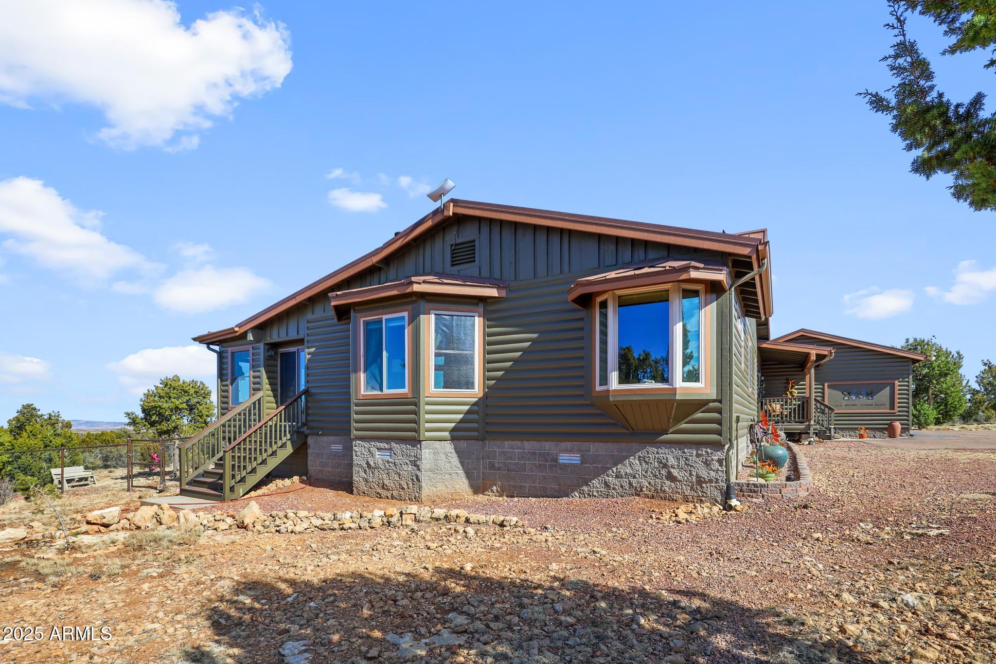 4018 Sunset Rdg Loop Happy Jack, AZ 86024 - Photo 35 of 46 a front view of a house with a yard
