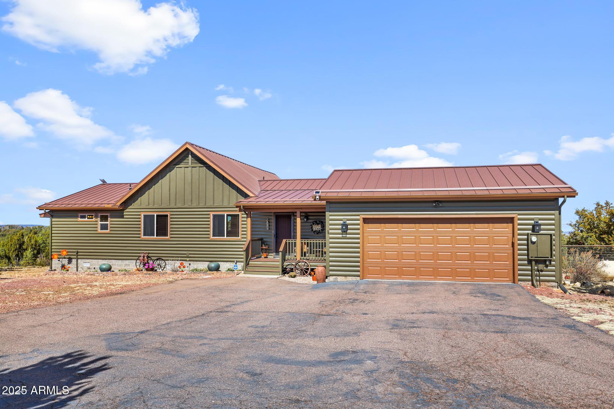 4018 Sunset Rdg Loop Happy Jack, AZ 86024 - Photo 45 of 46 a front view of a house with a yard and garage