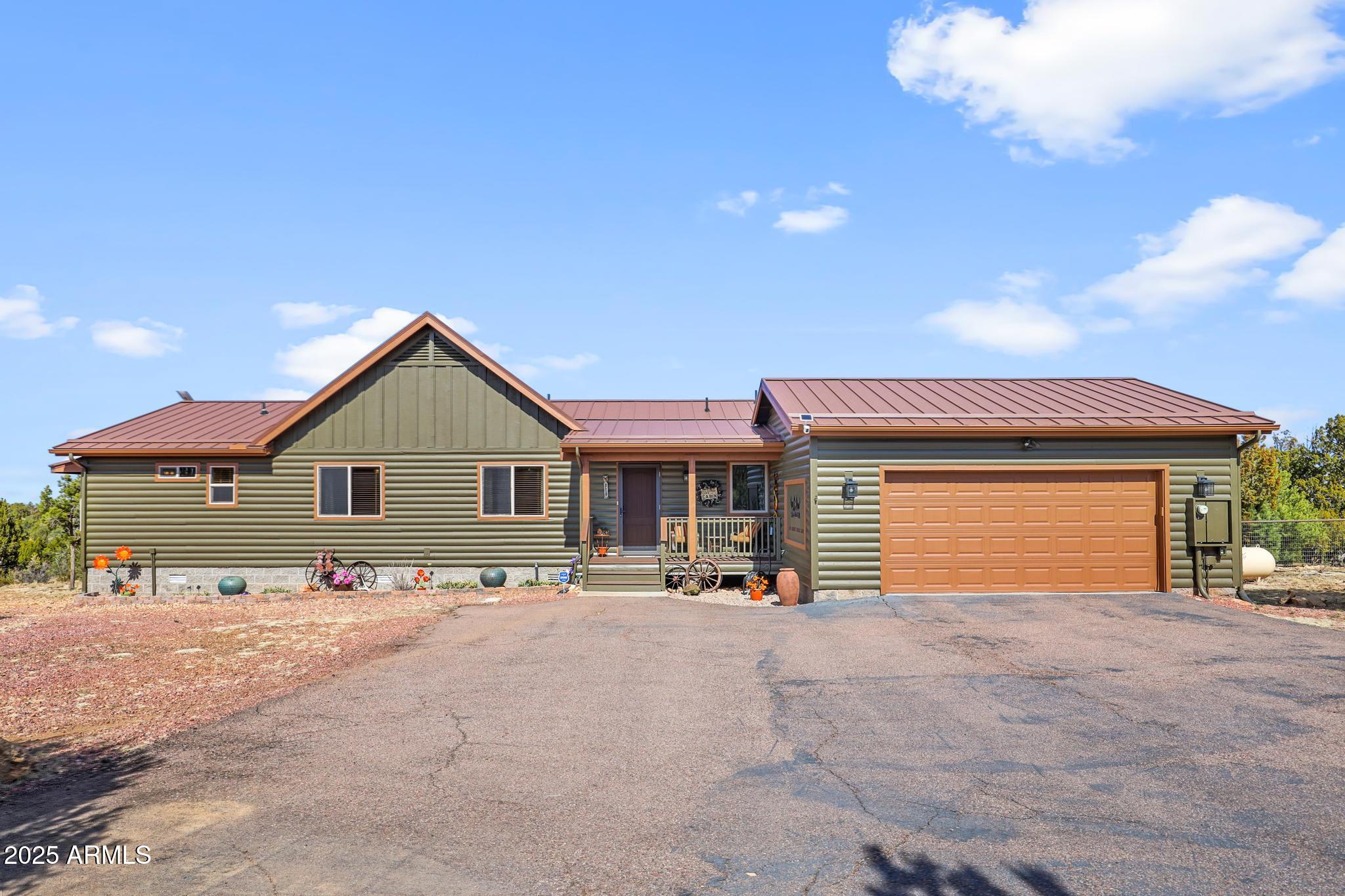 4018 Sunset Rdg Loop Happy Jack, AZ 86024 - Photo 46 of 46 a view of a house with a yard and garage