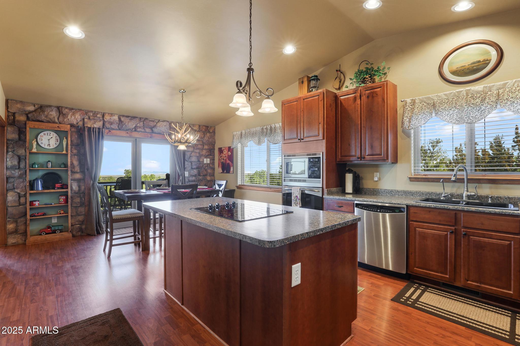 4018 Sunset Rdg Loop Happy Jack, AZ 86024 - Photo 5 of 46 a kitchen with stainless steel appliances granite countertop a sink a stove and a wooden floors