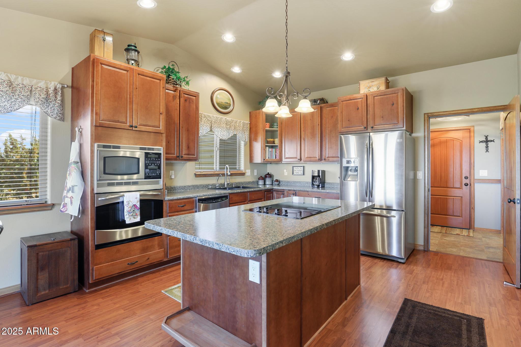 4018 Sunset Rdg Loop Happy Jack, AZ 86024 - Photo 8 of 46 a kitchen with stainless steel appliances granite countertop a sink a stove and a refrigerator