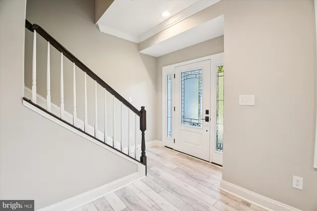 a view of an entryway with wooden floor