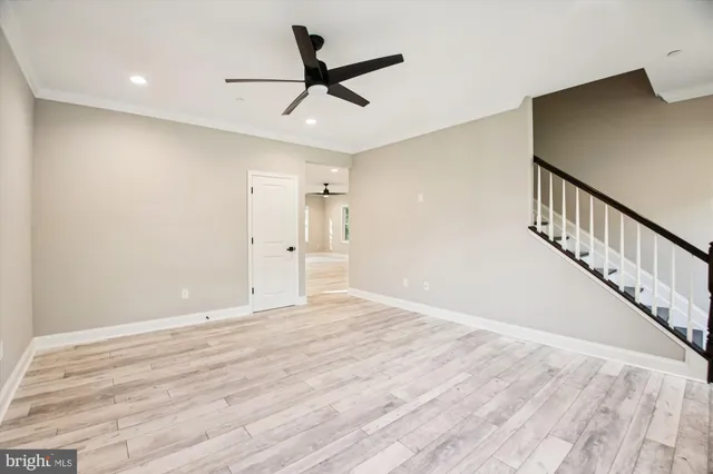 a view of empty room with wooden floor