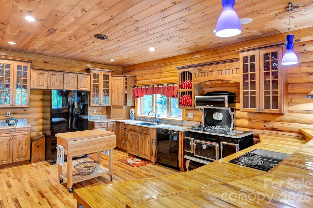 35 Falcon Crest Loop Maggie Valley, NC 28751 - Photo 12 of 46 a kitchen with stainless steel appliances kitchen island granite countertop a stove and cabinets