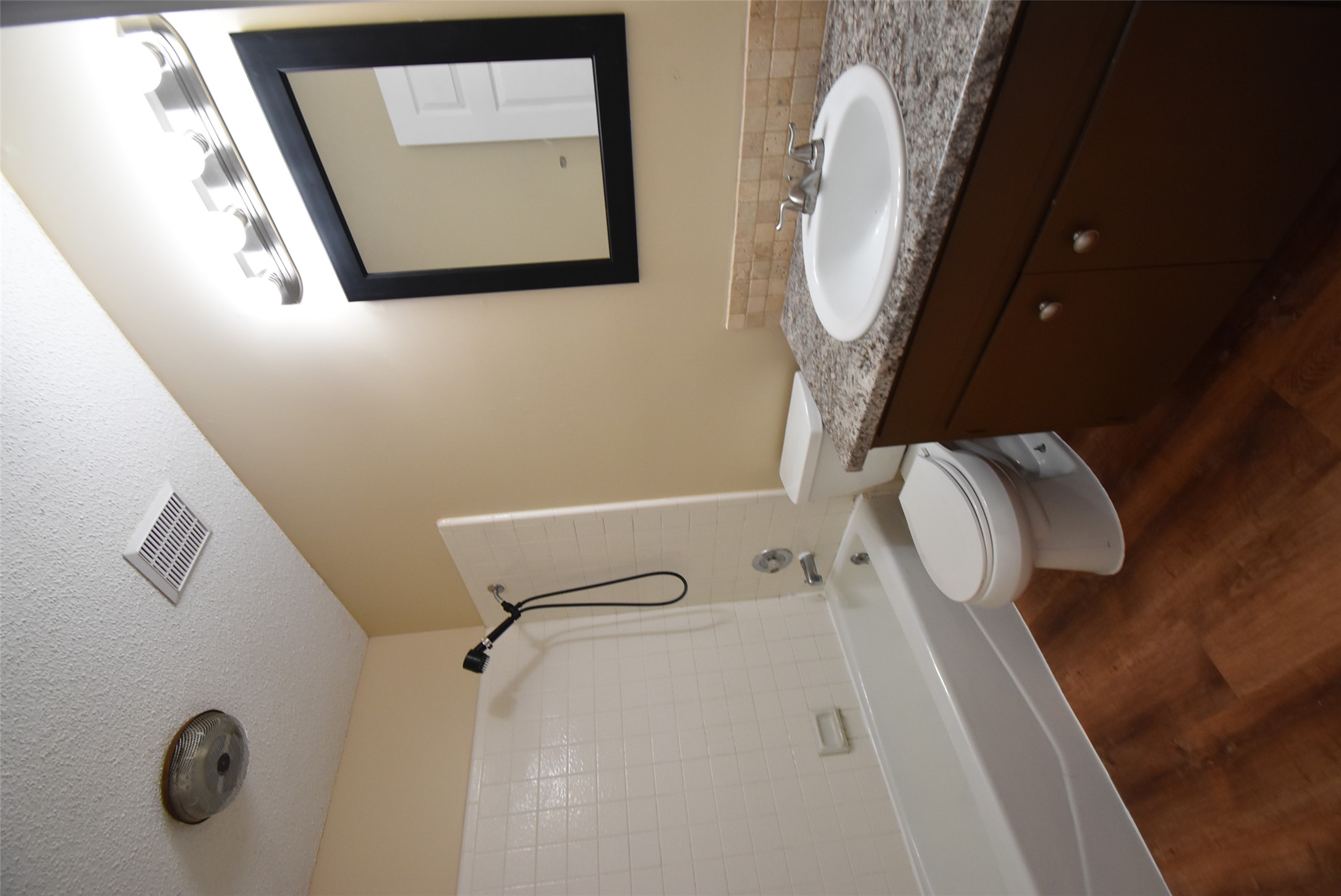 1806 Rawhide Loop Round Rock, TX 78681 - Photo 20 of 23 Bathroom featuring shower / bathtub combination, vanity, vinyl floors, and textured ceiling