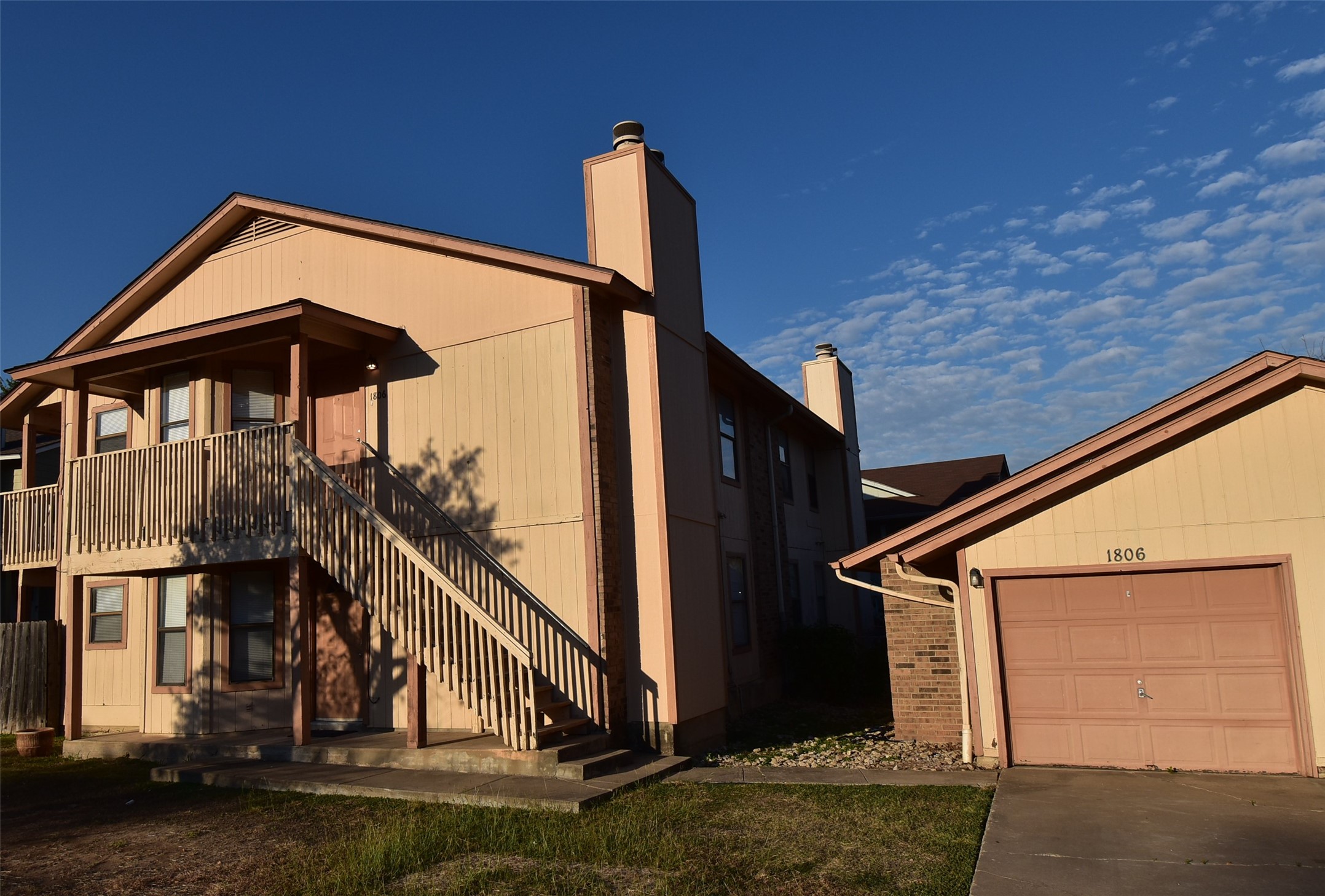 1806 Rawhide Loop Round Rock, TX 78681 - Photo 22 of 23 View of front of property with a chimney, detached garage, and concrete driveway