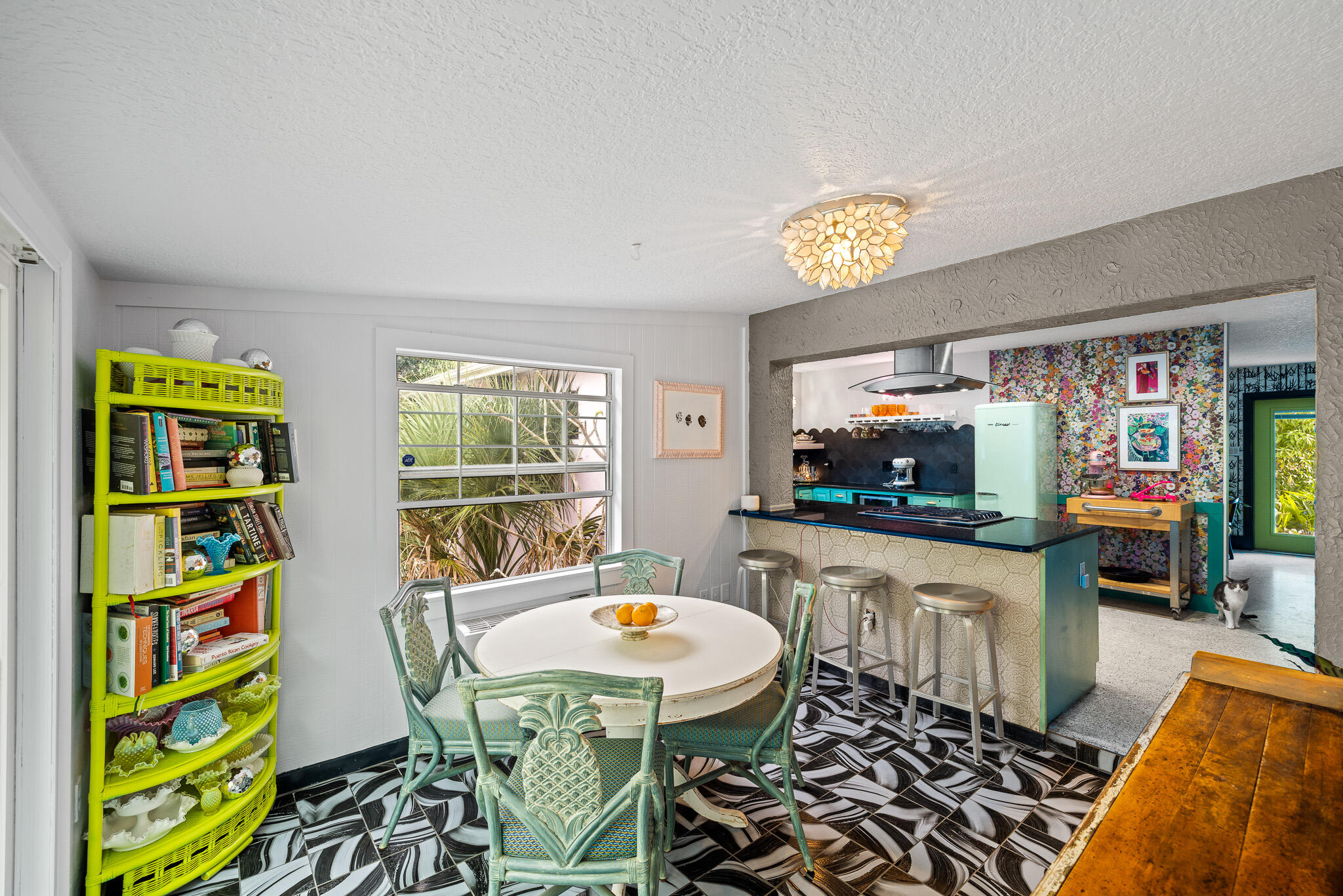 270 Richards Road Melbourne Beach, FL 32951 - Photo 27 of 41 a kitchen with stainless steel appliances a dining table and chairs