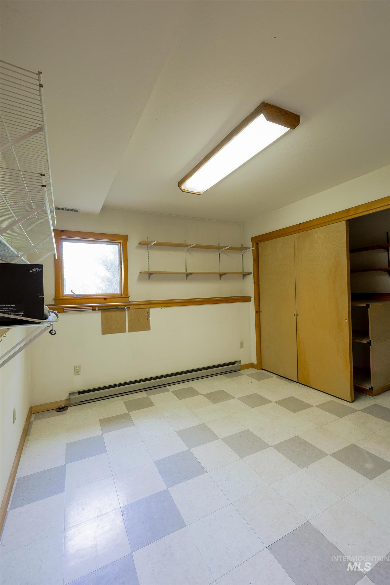 1021 Claypit Road Troy, ID 83871 - Photo 32 of 44 Interior space with light floors and a baseboard heating unit