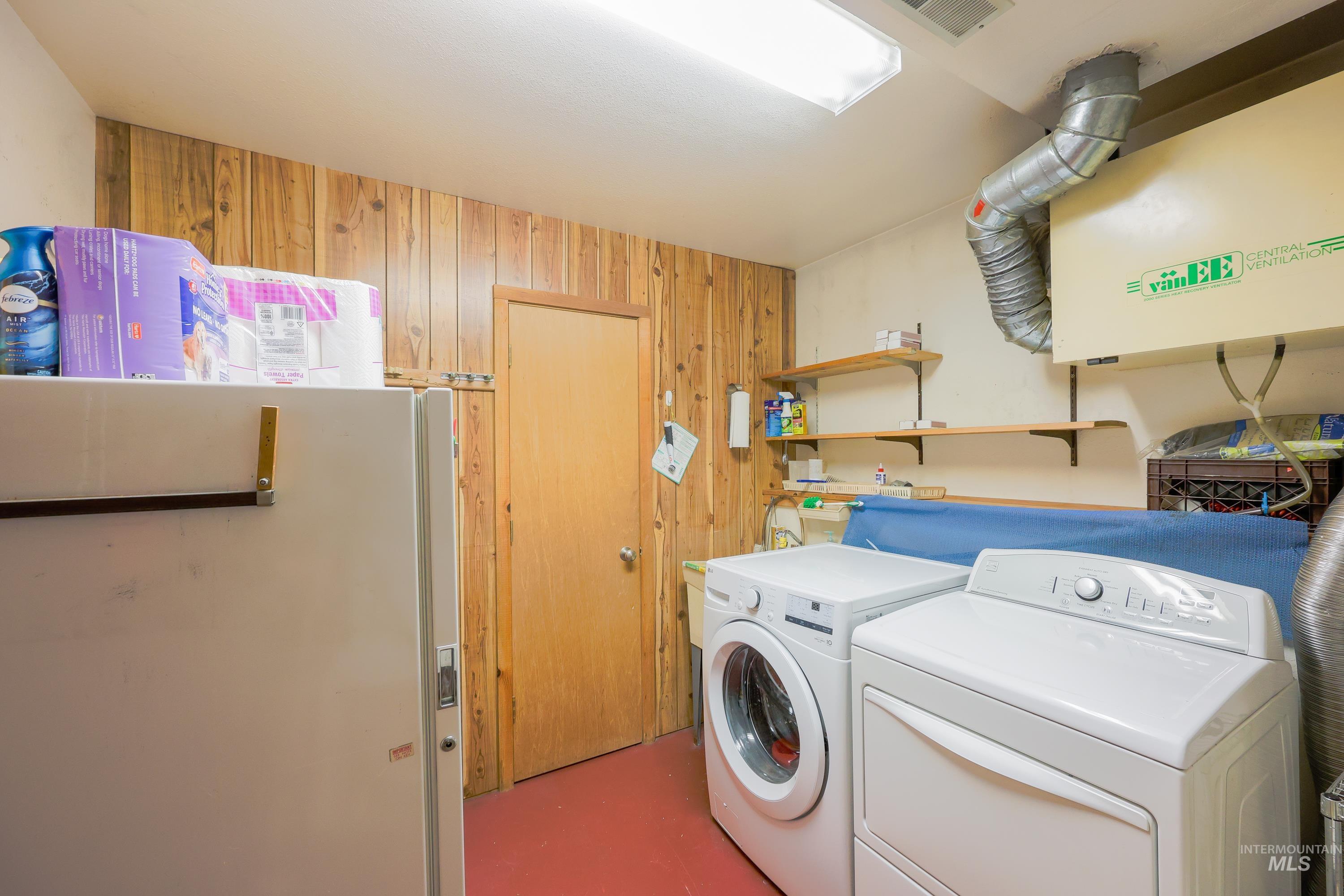 1021 Claypit Road Troy, ID 83871 - Photo 35 of 44 Washroom with wooden walls and separate washer and dryer