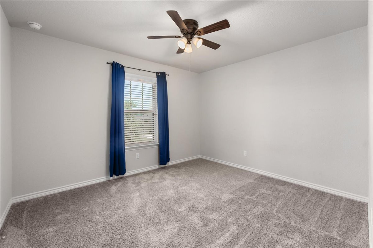 5408 Vanner Path Georgetown, TX 78626 - Photo 23 of 34 Carpeted room featuring a ceiling fan with integrated lighting, a window with horizontal blinds, and baseboard trim