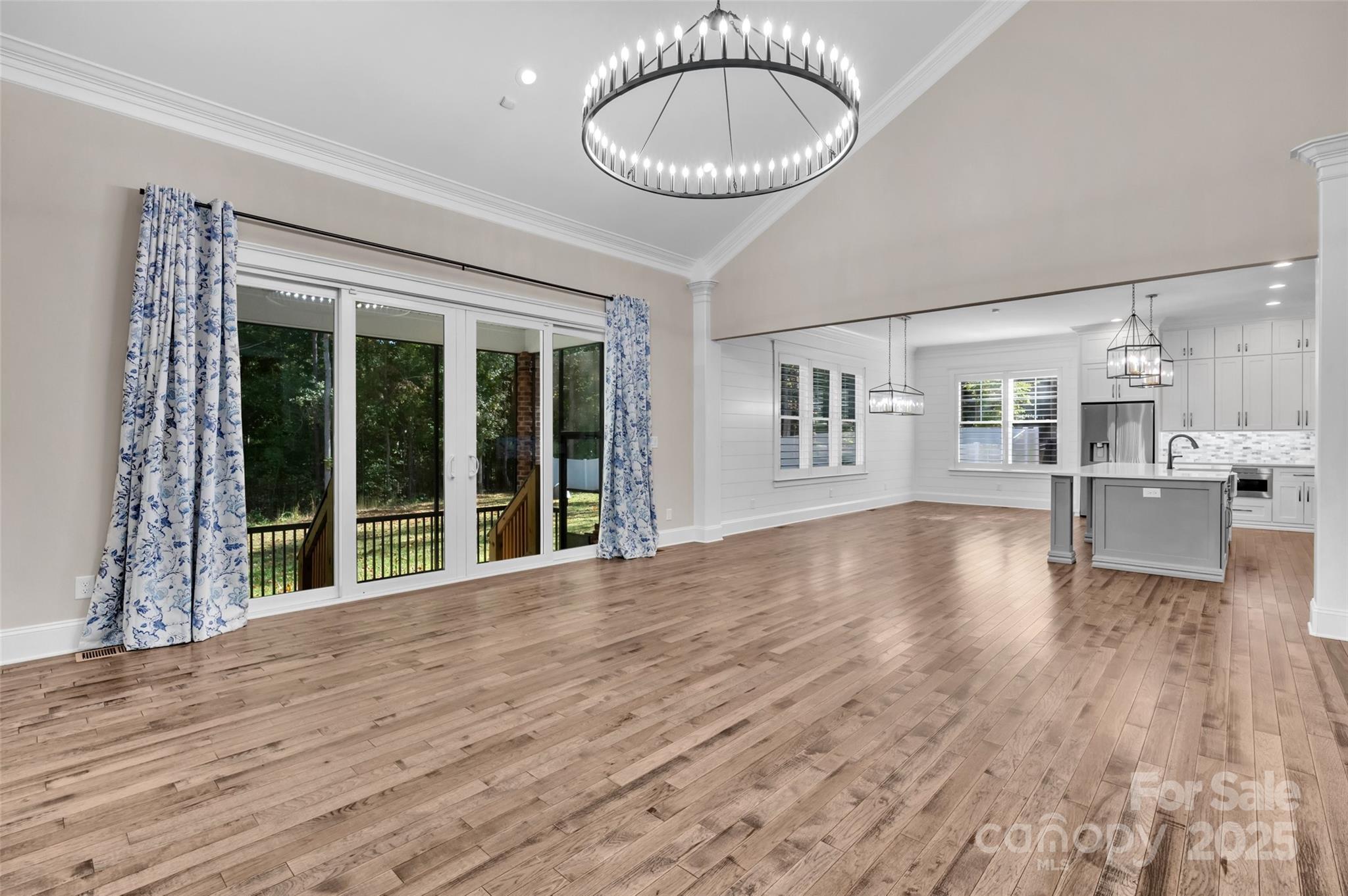 1622 Hunters Place Road York, SC 29745 - Photo 11 of 39 a view of an empty room with a kitchen and wooden floor