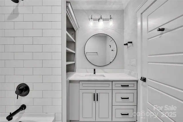 a bathroom with a double vanity sink a mirror and a bathtub