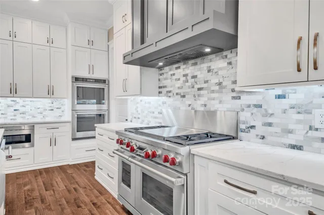a kitchen with a sink stove and cabinets