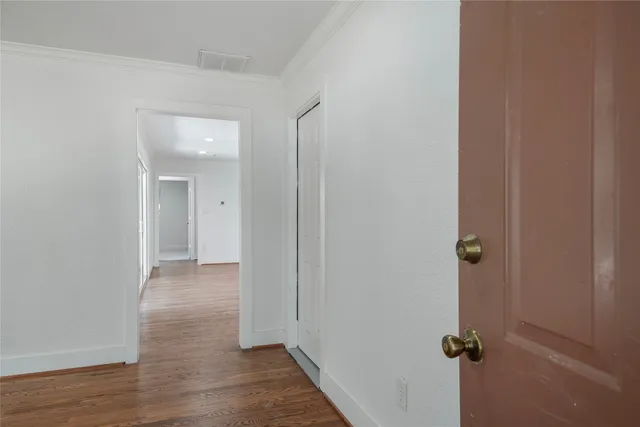 a view of a room with wooden floor