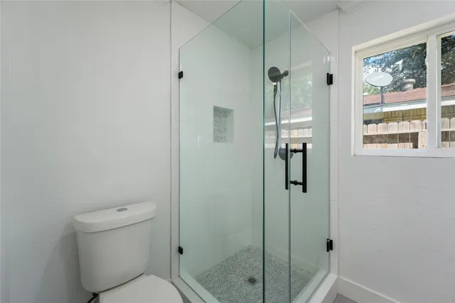 a bathroom with a shower and toilet