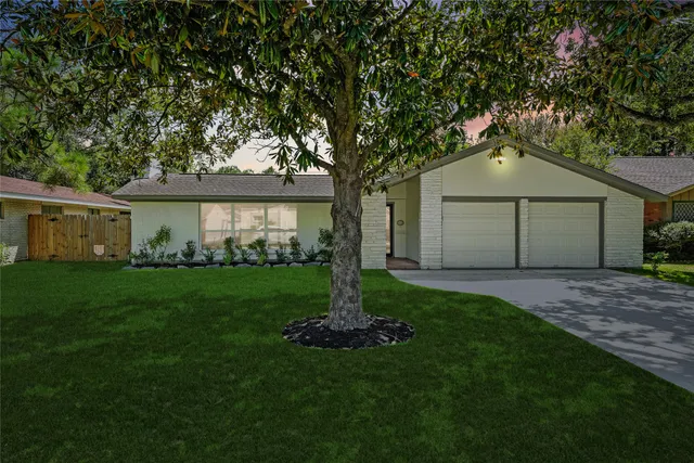 a front view of a house with a garden and yard