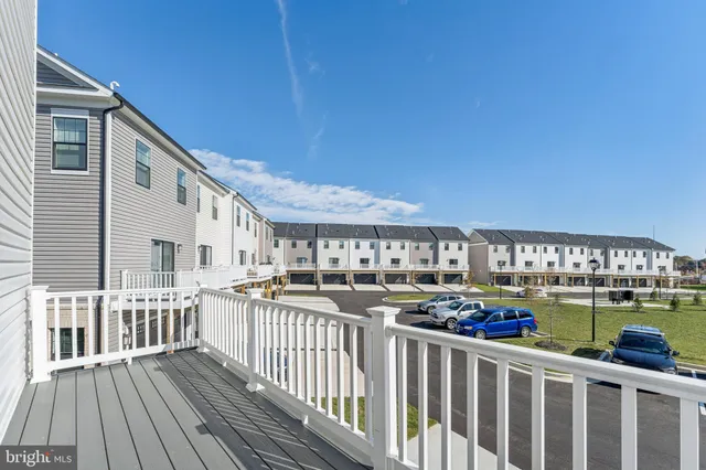 a view of a balcony with wooden floor and fence