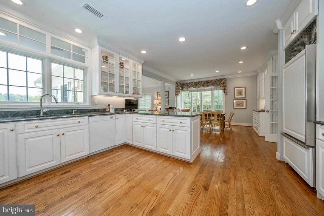 1201 Denbigh Lane Wayne, PA 19087 - Photo 11 of 54 a large kitchen with stainless steel appliances granite countertop a lot of counter space and wooden floors