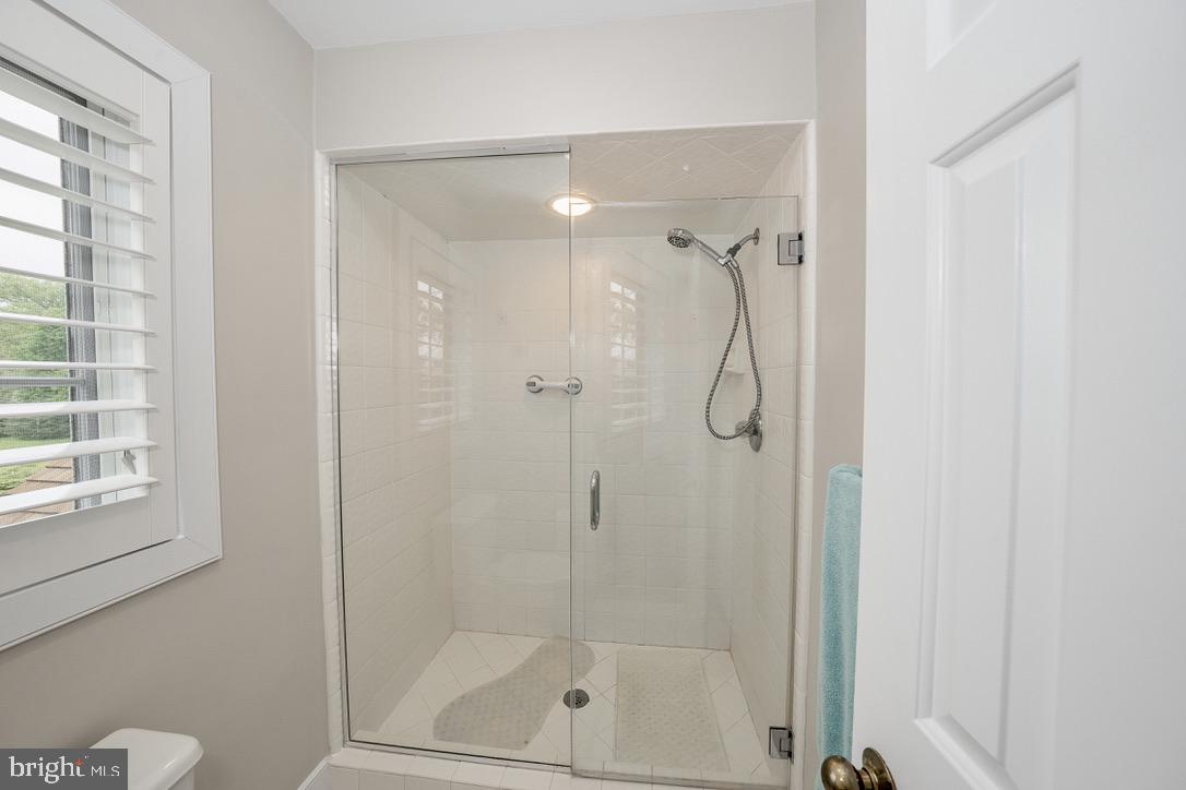 1201 Denbigh Lane Wayne, PA 19087 - Photo 33 of 54 a bathroom with a glass shower door