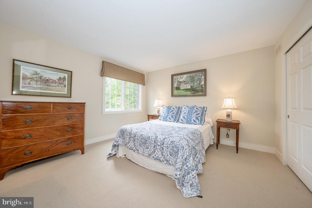 1201 Denbigh Lane Wayne, PA 19087 - Photo 36 of 54 a bedroom with a bed and a lamp on dresser