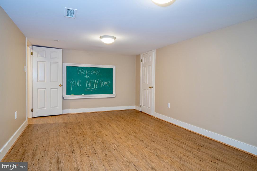 1201 Denbigh Lane Wayne, PA 19087 - Photo 42 of 54 a view of an empty room with window and wooden floor