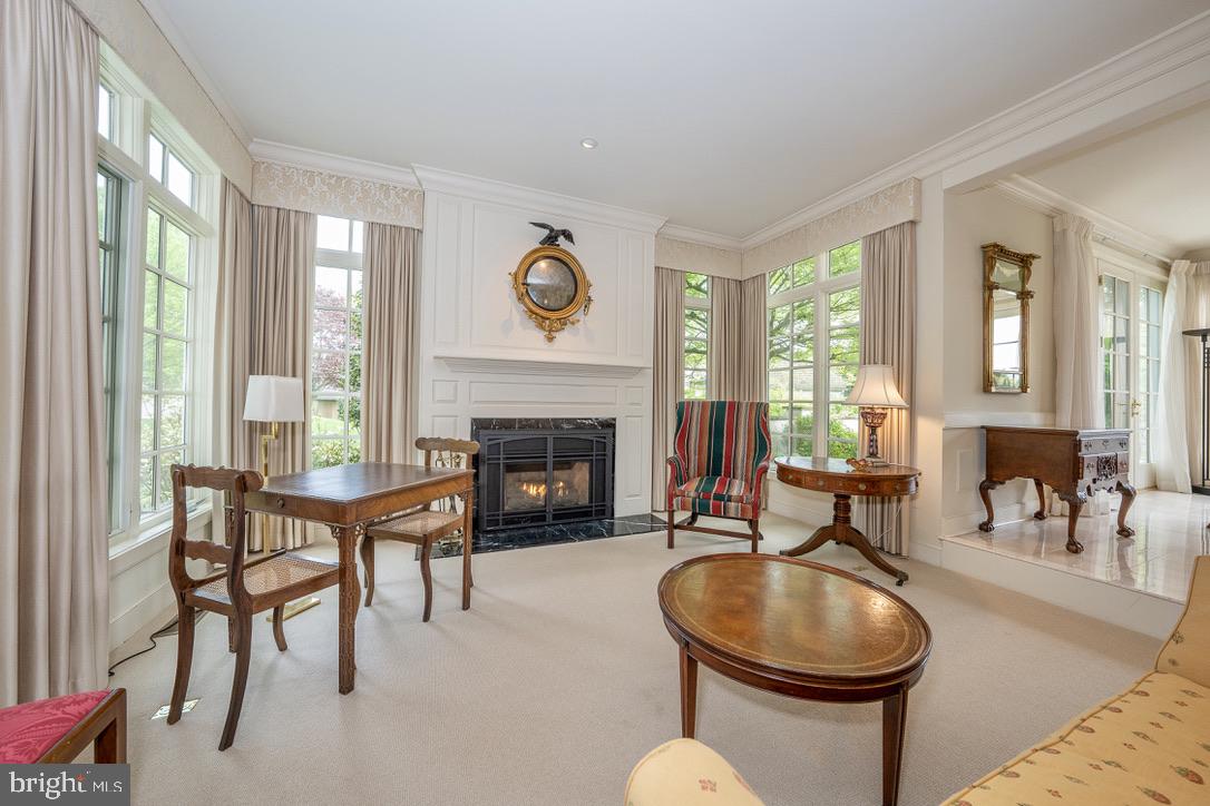 1201 Denbigh Lane Wayne, PA 19087 - Photo 5 of 54 a living room with furniture a fireplace and a large window