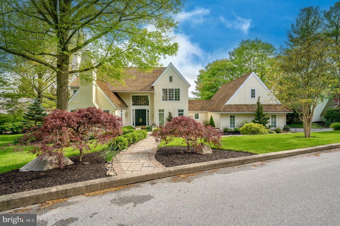 1201 Denbigh Lane Wayne, PA 19087 - Photo 54 of 54 a front view of a house with a garden and trees