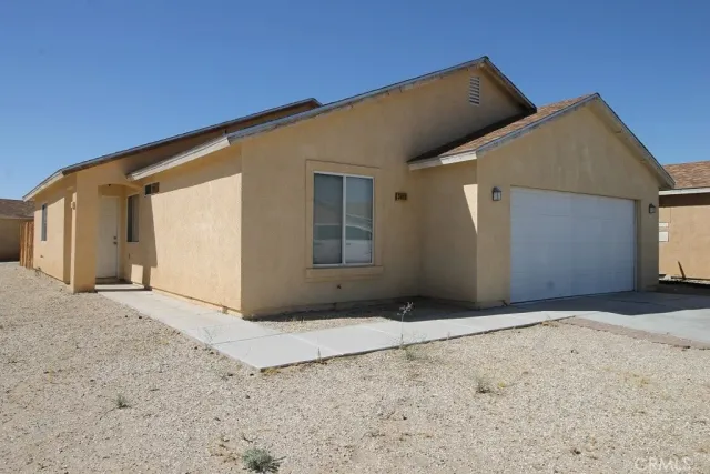 a view of a house with a wooden fence