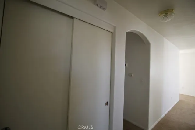 a view of closet with wooden floor