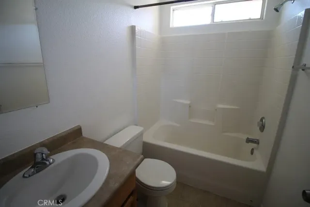 a white toilet sitting next to a bath tub