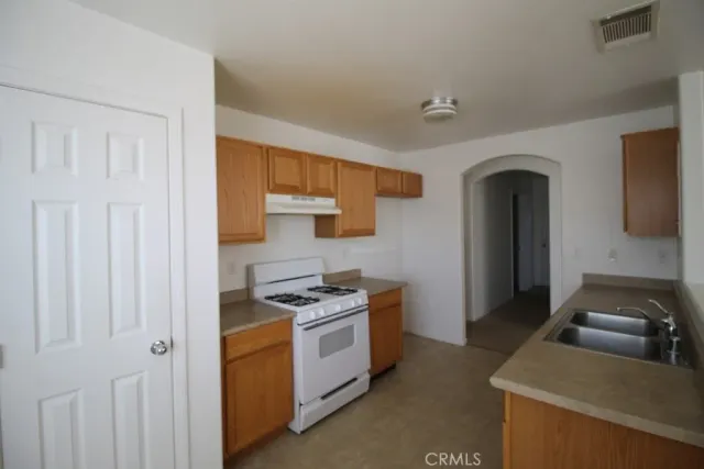 a kitchen that has a sink and a stove