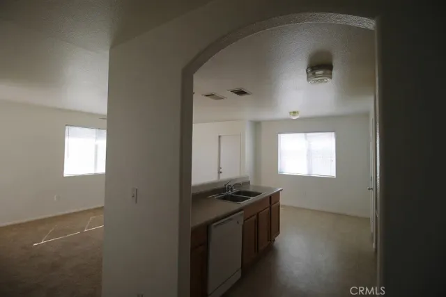 a kitchen with stainless steel appliances a refrigerator and a stove top oven