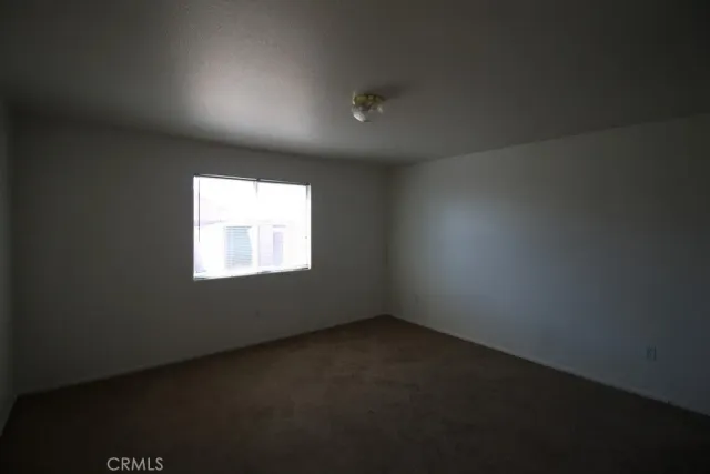 a view of an empty room and a window