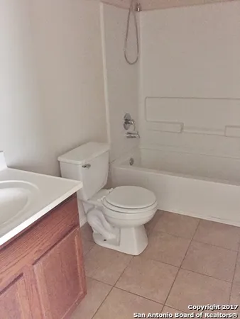 a white toilet sitting next to a bath tub