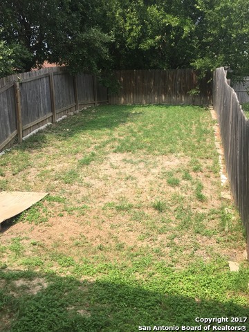 10003 Vasso View, Unit 2 Converse, TX 78109 - Photo 16 of 16 a backyard of a house with lots of green space