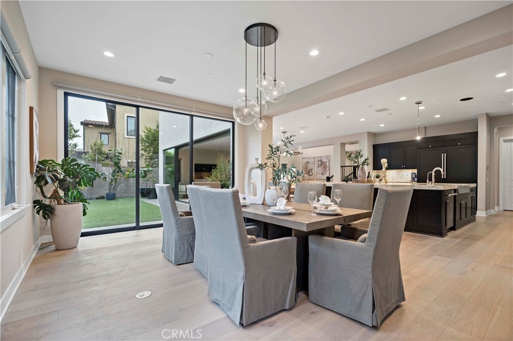 115 Interstellar Irvine, CA 92618 - Photo 11 of 36 a dining room with furniture and a floor to ceiling window