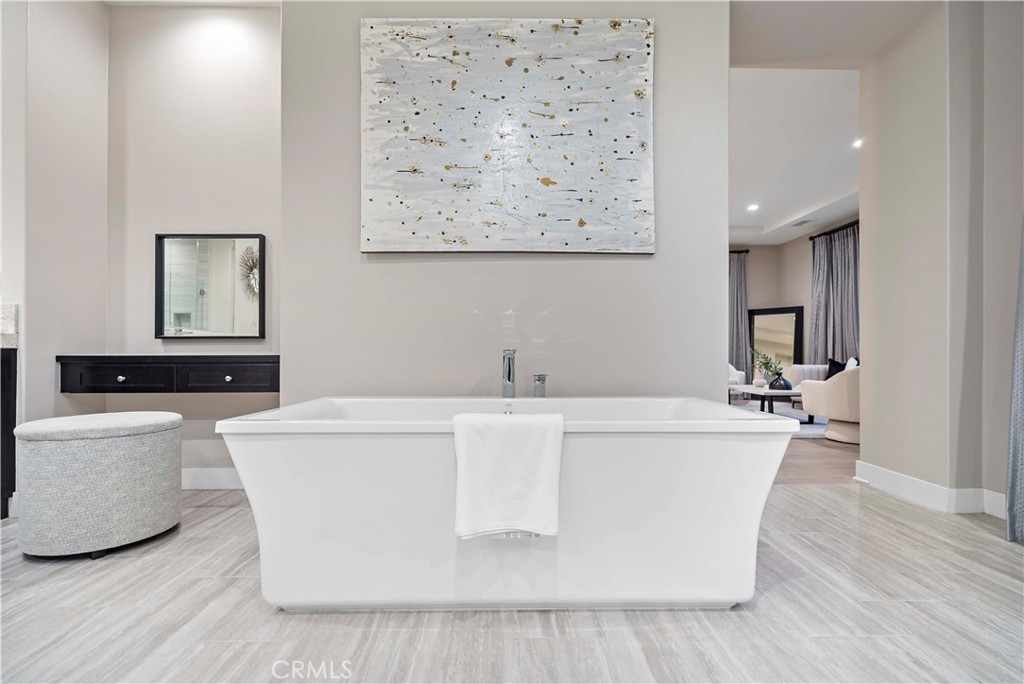 115 Interstellar Irvine, CA 92618 - Photo 29 of 36 a white room with a white table a couch and a potted plant