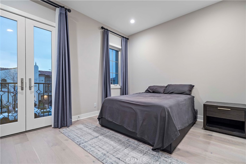115 Interstellar Irvine, CA 92618 - Photo 30 of 36 a spacious bedroom with a bed and glass door