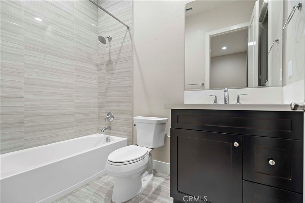 115 Interstellar Irvine, CA 92618 - Photo 33 of 36 a bathroom with a sink a toilet and shower