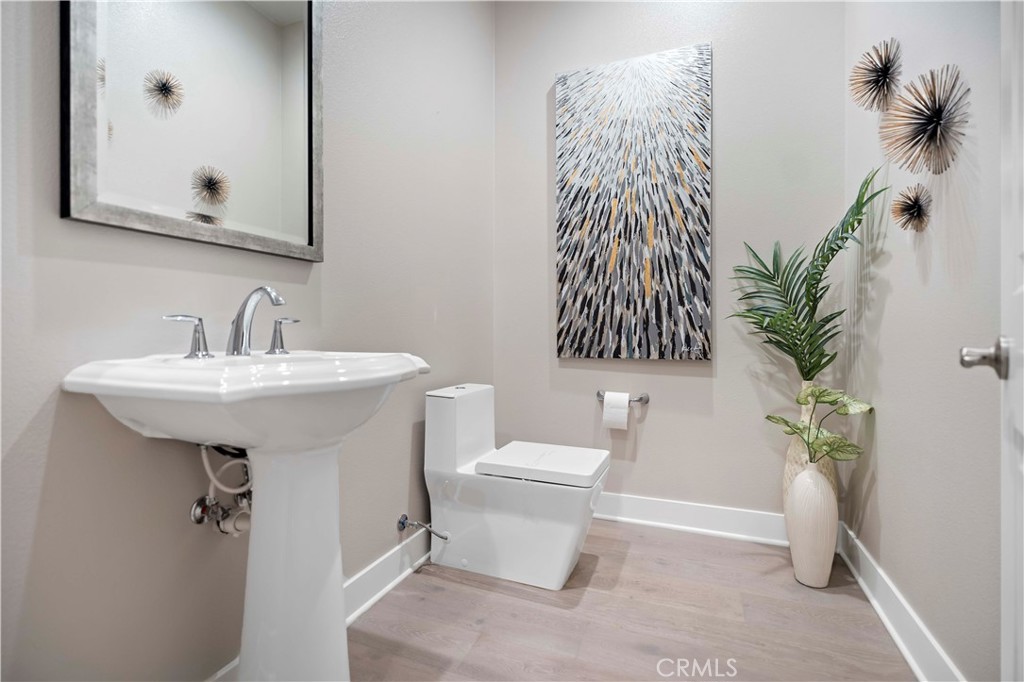 115 Interstellar Irvine, CA 92618 - Photo 4 of 36 a bathroom with a sink toilet and a mirror