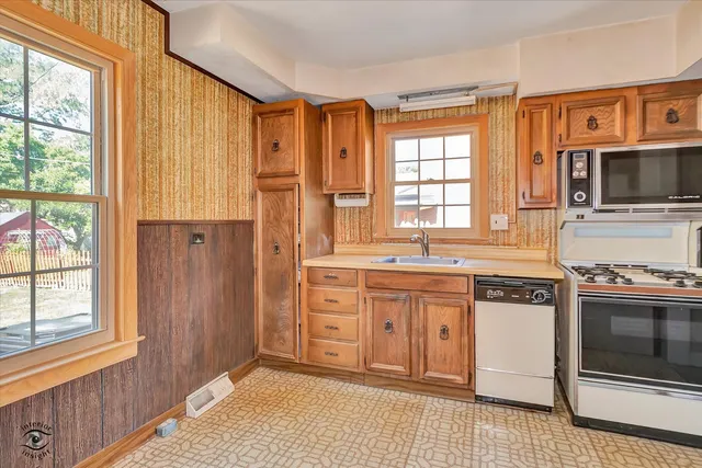 a kitchen with stainless steel appliances granite countertop a stove and a microwave