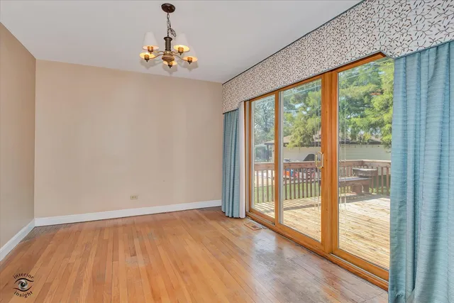 a view of a livingroom with wooden floor and a large window