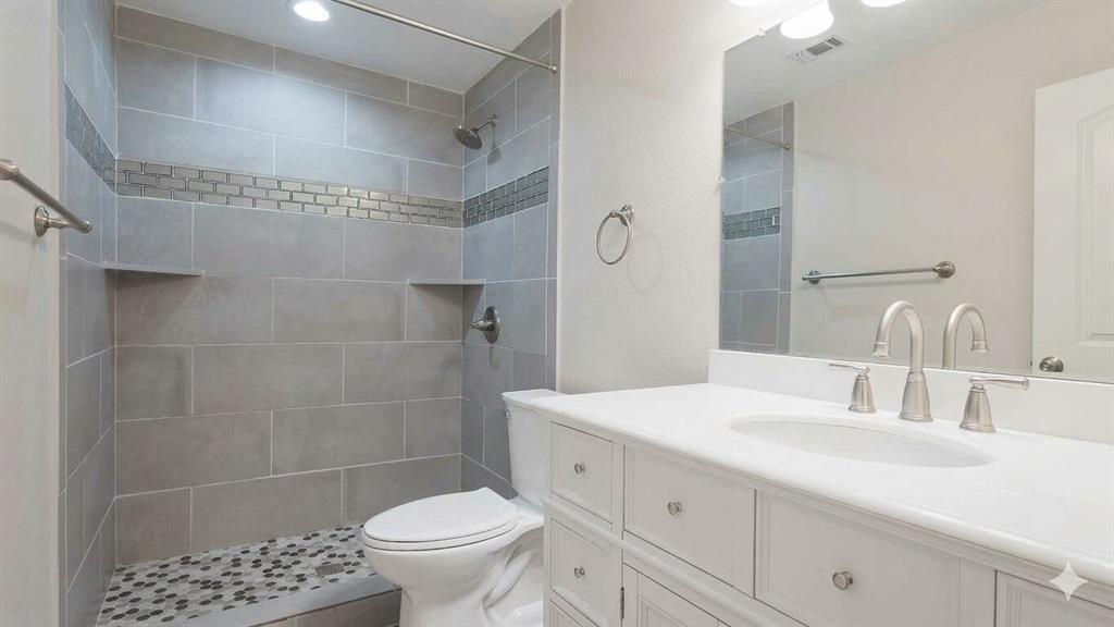 211 Vista Ridge Drive Venus, TX 76084 - Photo 20 of 24 Bathroom vanity featuring a white countertop with an undermount sink and brushed nickel faucet