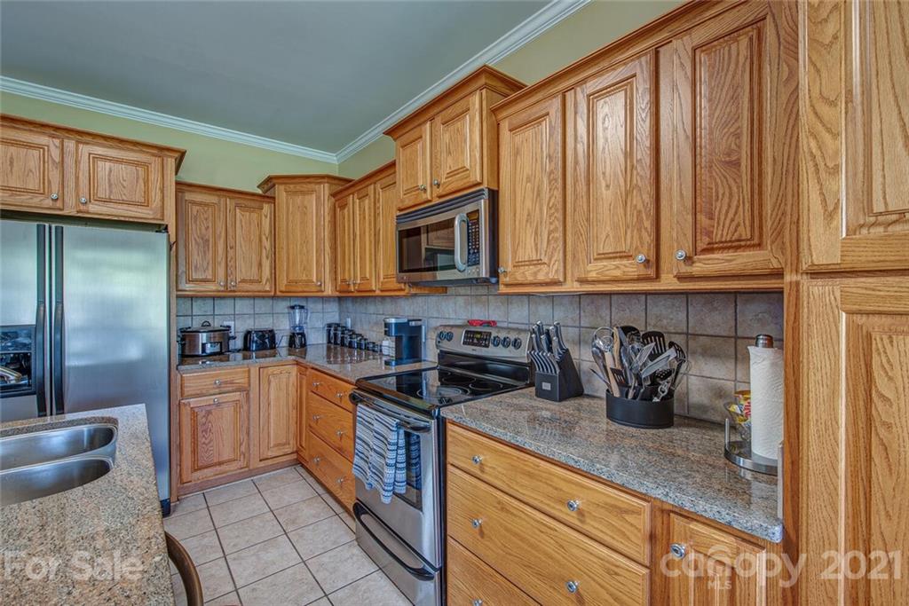 936 Ferguson Ridge Road Gastonia, NC 28052 - Photo 12 of 30 a kitchen with stainless steel appliances granite countertop a stove a sink and a microwave