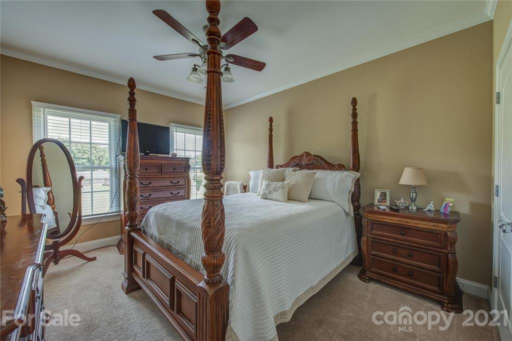 936 Ferguson Ridge Road Gastonia, NC 28052 - Photo 16 of 30 a bed room with a bed and a chandelier